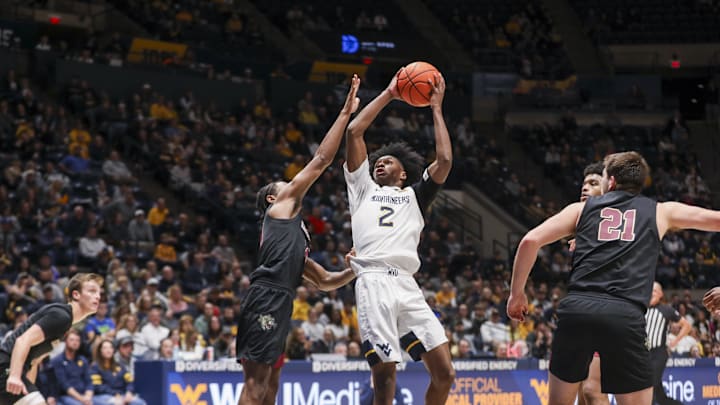 Nov 17, 2025; Morgantown, West Virginia, USA; West Virginia Mountaineers guard Amir Jenkins (2) shoots in the lane against Lafayette Leopards guard Mark Butler (10) during the second half at WVU Coliseum. Mandatory Credit: Ben Queen-Imagn Images