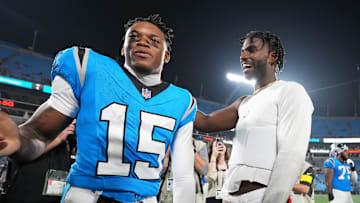 Cleveland Browns quarterback Shedeur Sanders with Carolina Panthers wide receiver Jimmy Horn Jr. after the game
