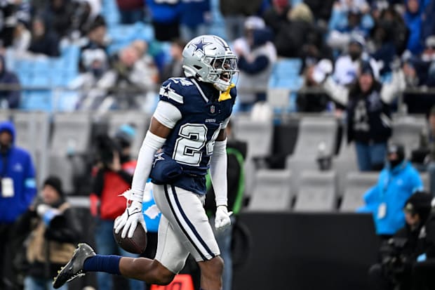 Dallas Cowboys safety Israel Mukuamu reacts after intercepting the ball in the fourth quarter at Bank of America Stadium.
