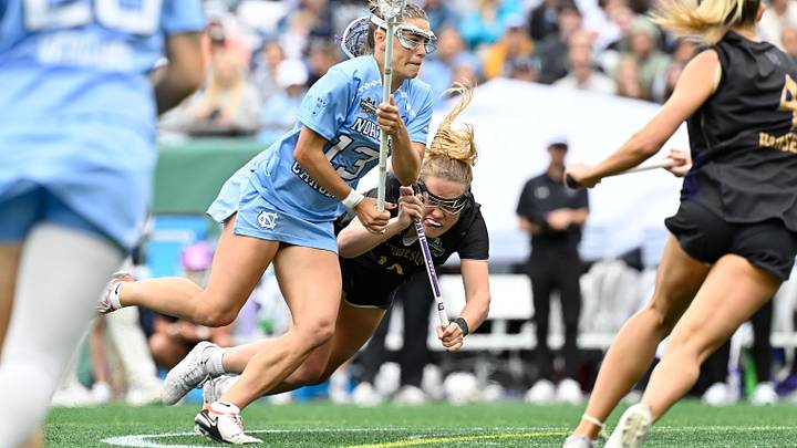 May 25, 2025; Foxborough, MA, USA; North Carolina Tar Heels midfielder Kate Levy (13) drives through Northwestern Wildcats midfielder Sam Smith (19) to the net during the second half at Gillette Stadium. Mandatory Credit: Eric Canha-Imagn Images