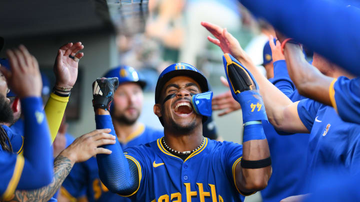 Seattle Mariners center fielder Julio Rodriguez (44) celebrates in the dugout after scoring a run against the Toronto Blue Jays during the third inning at T-Mobile Park on July 5.