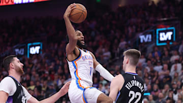 Nov 21, 2025; Salt Lake City, Utah, USA; Oklahoma City Thunder guard Isaiah Joe (11) goes to the basket against Utah Jazz center Jusuf Nurkic (30) and forward Kyle Filipowski (22) during the first half at Delta Center.
