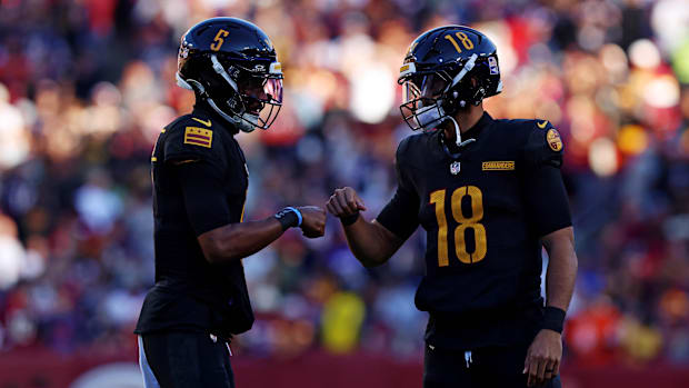 Oct 27, 2024; Landover, Maryland, USA; Washington Commanders quarterback Jayden Daniels (5) and quarterback Marcus Mariota (1
