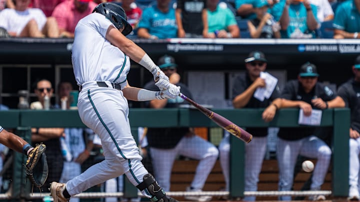 Jun 13, 2025; Omaha, Neb, USA; Coastal Carolina Chanticleers catcher Caden Bodine (17) hits a single against the Arizona Wildcats during the first inning at Charles Schwab Field. Mandatory Credit: Dylan Widger-Imagn Images