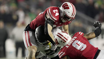 Wisconsin safety Hunter Wohler (24) tackles Oregon running back Da'Jaun Riggs (21) during the fourth quarter of their game Saturday, November 16, 2024 at Camp Randall Stadium in Madison, Wisconsin. Oregon beat Wisconsin 16-13.