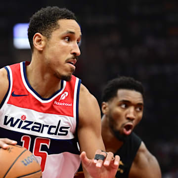 Dec 3, 2024; Cleveland, Ohio, USA; Washington Wizards guard Malcolm Brogdon (15) drives to the basket against Cleveland Cavaliers guard Donovan Mitchell (45) during the first quarter at Rocket Mortgage FieldHouse. Mandatory Credit: Ken Blaze-Imagn Images