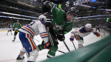 May 29, 2025; Dallas, Texas, USA; Edmonton Oilers center Mattias Janmark (13) checks Dallas Stars defenseman Lian Bichsel (6) during the second period in game five of the Western Conference Final of the 2025 Stanley Cup Playoffs at American Airlines Center. Mandatory Credit: Jerome Miron-Imagn Images