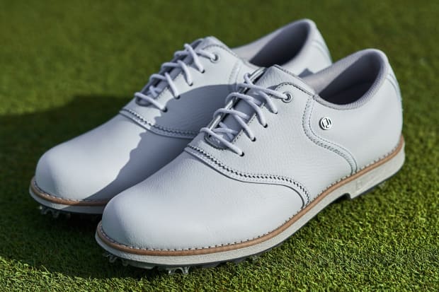 Side view of white FootJoy golf shoes.