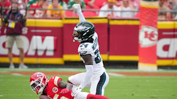 Sep 14, 2025; Kansas City, Missouri, USA; Philadelphia Eagles safety Andrew Mukuba (24) tackles Kansas City Chiefs wide receiver Hollywood Brown (5) during the third quarter of the game at GEHA Field at Arrowhead Stadium. Mandatory Credit: Denny Medley-Imagn Images