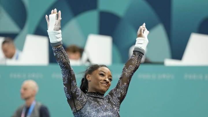 Jul 28, 2024; Paris, France; Simone Biles of the United States performs on the uneven bars in womenís qualification during the Paris 2024 Olympic Summer Games at Bercy Arena. Mandatory Credit: Kyle Terada-USA TODAY Sports