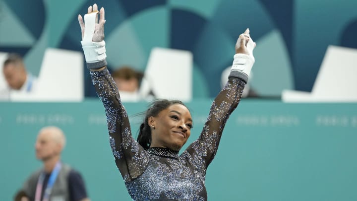 Jul 28, 2024; Paris, France; Simone Biles of the United States performs on the uneven bars in womenís qualification during the Paris 2024 Olympic Summer Games at Bercy Arena. Mandatory Credit: Kyle Terada-USA TODAY Sports