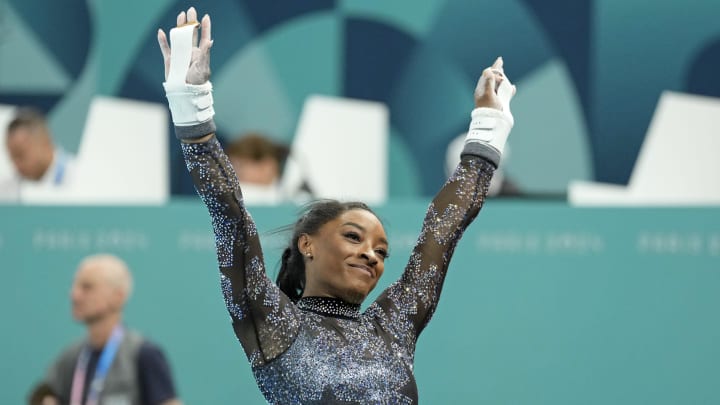 Simone Biles performs on the uneven bars in women's qualification during the Paris 2024 Olympic Summer Games at Bercy Arena. 