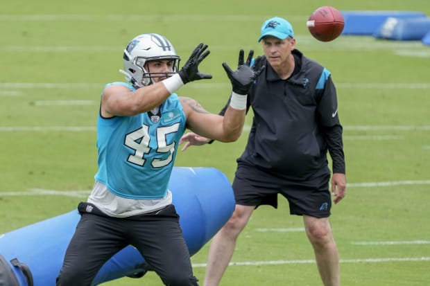 Tight end catches pass in practice during drill.