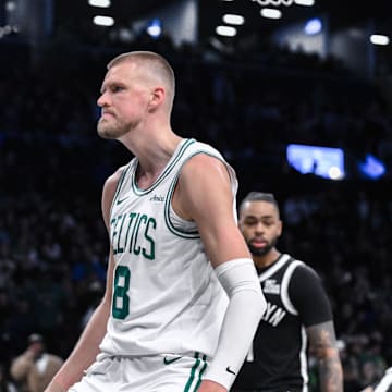 Mar 15, 2025; Brooklyn, New York, USA; Boston Celtics center Kristaps Porzingis (8) reacts after dunking the ball against the Brooklyn Nets during the second half at Barclays Center. Mandatory Credit: John Jones-Imagn Images