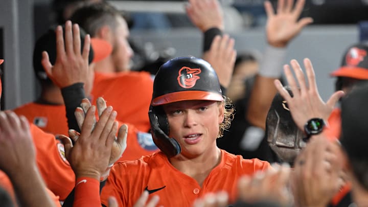 Mar 29, 2025; Toronto, Ontario, CAN; Baltimore Orioles shortstop Jackson Holliday (7) celebrates with team mates in the dugout after scoring against the Toronto Blue Jays in the fourth inning at Rogers Centre. Mandatory Credit: Dan Hamilton-Imagn Images