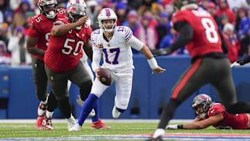 Nov 16, 2025; Orchard Park, New York, USA;  Buffalo Bills quarterback Josh Allen (17) scrambles against Tampa Bay Buccaneers defensive tackle Vita Vea (50) during the second half of the game at Highmark Stadium.
