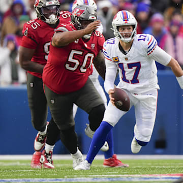 Nov 16, 2025; Orchard Park, New York, USA;  Buffalo Bills quarterback Josh Allen (17) scrambles against Tampa Bay Buccaneers defensive tackle Vita Vea (50) during the second half of the game at Highmark Stadium.