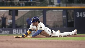 Aug 27, 2025; Milwaukee, Wisconsin, USA; Milwaukee Brewers outfielder Christian Yelich (22) slides safely into second base for a double against the Arizona Diamondbacks in the eighth inning at American Family Field. Mandatory Credit: Michael McLoone-Imagn Images