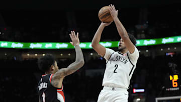 Jan 14, 2025; Portland, Oregon, USA; Brooklyn Nets small forward Cameron Johnson (2) shoots the ball over Portland Trail Blazers shooting guard Anfernee Simons (1) during the first half at Moda Center. Mandatory Credit: Soobum Im-Imagn Images