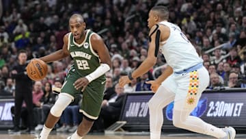 Jan 8, 2025; Milwaukee, Wisconsin, USA;  Milwaukee Bucks forward Khris Middleton (22) drives for the basket against San Antonio Spurs forward Keldon Johnson (0) during the third quarter at Fiserv Forum. Mandatory Credit: Jeff Hanisch-Imagn Images