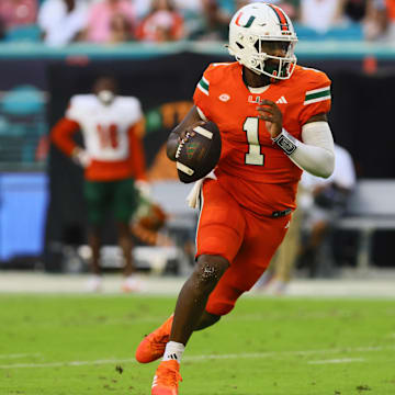 Sep 7, 2024; Miami Gardens, Florida, USA; Miami Hurricanes quarterback Cam Ward (1) runs with the football against the Florida A&M Rattlers during the second quarter at Hard Rock Stadium. Mandatory Credit: Sam Navarro-Imagn Images