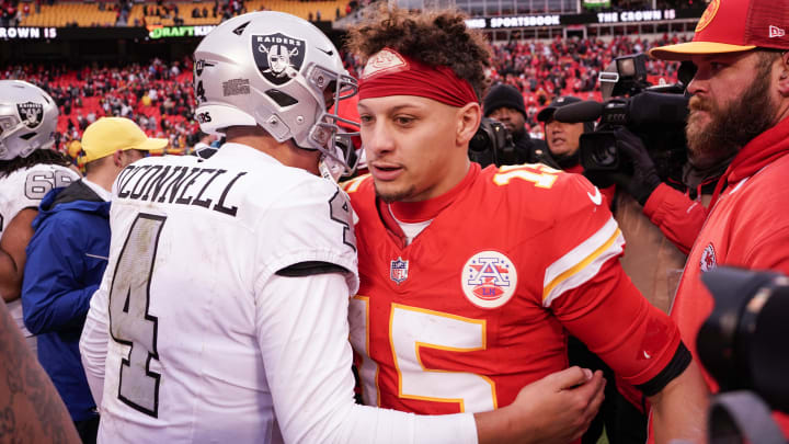 Dec 25, 2023; Kansas City, Missouri, USA; Kansas City Chiefs quarterback Patrick Mahomes (15) embraces Las Vegas Raiders quarterback Aidan O'Connell (4) after the game at GEHA Field at Arrowhead Stadium. Mandatory Credit: Denny Medley-USA TODAY Sports