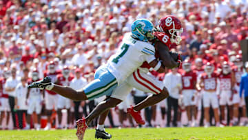 Sep 14, 2024; Norman, Oklahoma, USA;  Oklahoma Sooners wide receiver Deion Burks (6) runs with the ball as Tulane Green Wave safety Caleb Ransaw (7) defends during the first half at Gaylord Family-Oklahoma Memorial Stadium. Mandatory Credit: Kevin Jairaj-Imagn Images
