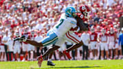 Sep 14, 2024; Norman, Oklahoma, USA;  Oklahoma Sooners wide receiver Deion Burks (6) runs with the ball as Tulane Green Wave safety Caleb Ransaw (7) defends during the first half at Gaylord Family-Oklahoma Memorial Stadium. Mandatory Credit: Kevin Jairaj-Imagn Images