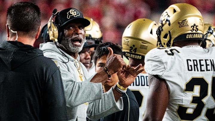 Sep 7, 2024; Lincoln, Nebraska, USA; Colorado Buffaloes head coach Deion Sanders talks with players during a timeout in the third quarter against the Nebraska Cornhuskers at Memorial Stadium. Mandatory Credit: Dylan Widger-Imagn Images