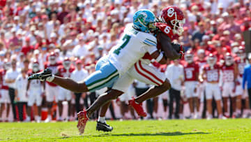 Sep 14, 2024; Norman, Oklahoma, USA;  Oklahoma Sooners wide receiver Deion Burks (6) runs with the ball as Tulane Green Wave safety Caleb Ransaw (7) defends during the first half at Gaylord Family-Oklahoma Memorial Stadium. 