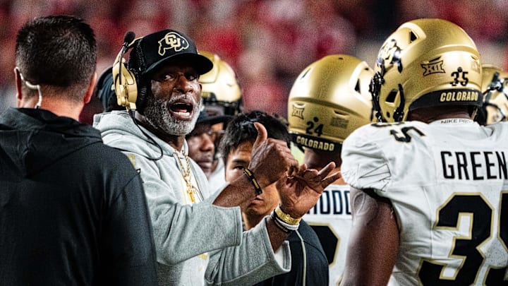 Sep 7, 2024; Lincoln, Nebraska, USA; Colorado Buffaloes head coach Deion Sanders talks with players during a timeout in the third quarter against the Nebraska Cornhuskers at Memorial Stadium. Mandatory Credit: Dylan Widger-Imagn Images