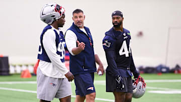 Jun 10, 2025; Foxborough, MA, USA; New England Patriots head coach Mike Vrabel speaks to defensive end Keion White (99) and linebacker K'Lavon Chaisson (44) after minicamp held in the WIN Field House at Gillette Stadium. Mandatory Credit: Eric Canha-Imagn Images