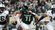 Nov 15, 2025; East Lansing, Michigan, USA; Michigan State Spartans quarterback Alessio Milivojevic (11) runs out of the pocket as Penn State Nittany Lions linebacker Amare Campbell (24) and defensive end Zuriah Fisher (36) chase in the first quarter at Spartan Stadium.