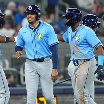 Tampa Bay Rays third baseman Junior Caminero (center) hits a grand slam and celebrates teammates on Tuesday night in Toronto.