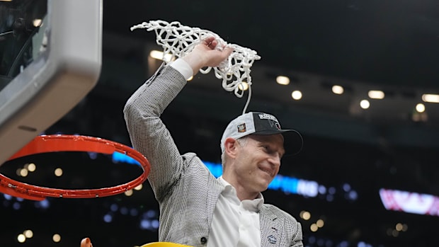 Alabama Crimson Tide head coach Nate Oats cuts the net after advancing to the 2024 Final Four.