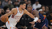 Oct 24, 2025; Inglewood, California, USA; Phoenix Suns guard Devin Booker (1) is defended by Los Angeles Clippers guard Kris Dunn (8) in the first half at Intuit Dome. Mandatory Credit: Jayne Kamin-Oncea-Imagn Images