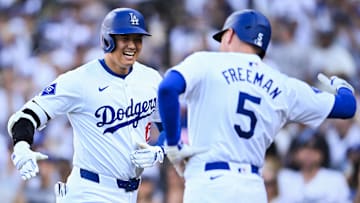 Los Angeles Dodgers designated hitter Shohei Ohtani (17) celebrates with first baseman Freddie Freeman (5) after hitting a home run against the Boston Red Sox at Dodger Stadium. 