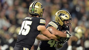 Purdue Boilermakers quarterback Ryan Browne (15) hands off the ball to running back Devin Mockobee (45) 