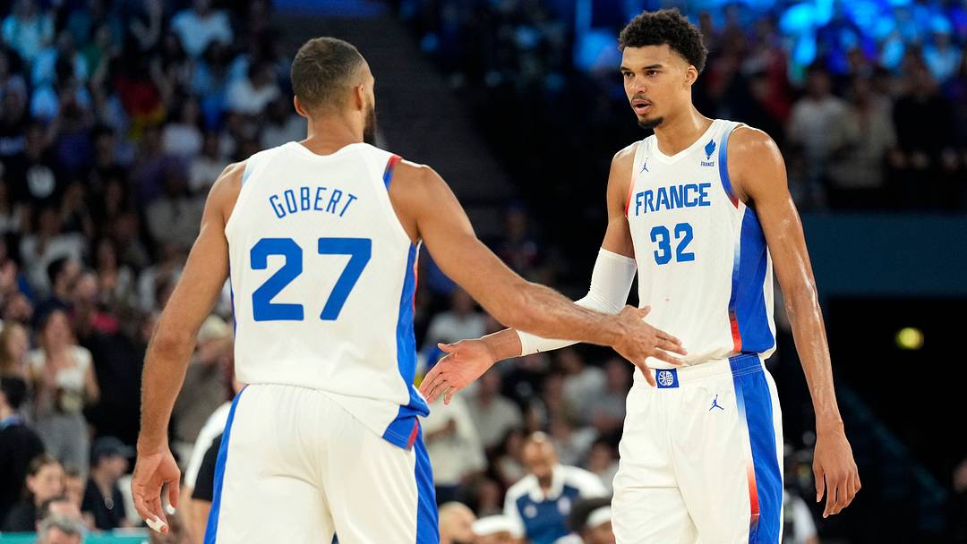 Aug 8, 2024; Paris, France; Team France centers Rudy Gobert (27) and Victor Wembanyama (32) celebrate during the first half against Germany in a men's basketball semifinal game during the Paris 2024 Olympic Summer Games at Accor Arena.