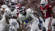 Texas A&M Aggies linebacker Chris Russell Jr. (24) and defensive lineman Malick Sylla (92) celebrate a sack of Arkansas Razorbacks quarterback KJ Jefferson (1) during the second half at AT&T Stadium.