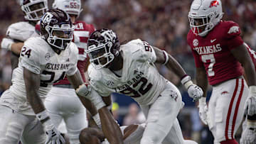 Texas A&M Aggies linebacker Chris Russell Jr. (24) and defensive lineman Malick Sylla (92) celebrate a sack of Arkansas Razorbacks quarterback KJ Jefferson (1) during the second half at AT&T Stadium.