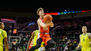 Jan 2, 2025; Eugene, Oregon, USA; Illinois Fighting Illini guard Kasparas Jakucionis (32) drives to the basket during the second half against the Oregon Ducks at Matthew Knight Arena. Mandatory Credit: Craig Strobeck-Imagn Images