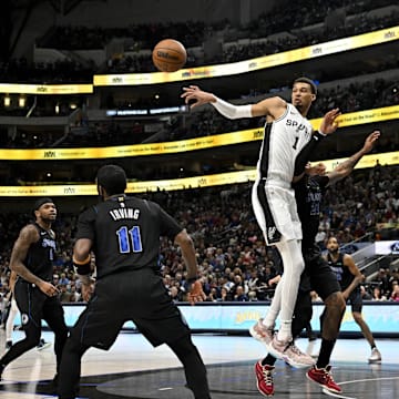 San Antonio Spurs center Victor Wembanyama (1) passes the ball over Dallas Mavericks guard Kyrie Irving (11) and guard Jaden Hardy (1) during the second half at the American Airlines Center. Mandatory Credit: Jerome Miron-Imagn Images