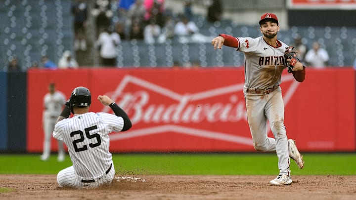 Sep 25, 2023; Bronx, New York, USA; Arizona Diamondbacks shortstop Jordan Lawlar (10) gets a force out against New York Yankees second baseman Gleyber Torres (25) during the sixth inning at Yankee Stadium. Mandatory Credit: John Jones-Imagn Images