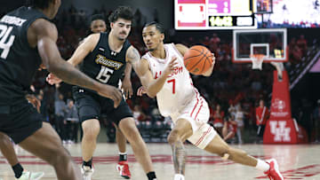 Nov 8, 2025; Houston, Texas, USA; Houston Cougars guard Milos Uzan (7) drives witht the ball as Towson Tigers guard Tyler Tejada (15) defends during the second half at Fertitta Center. Mandatory Credit: Troy Taormina-Imagn Images