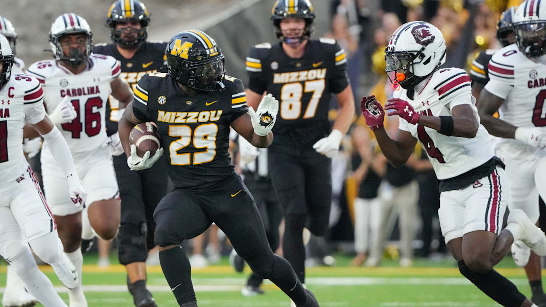Sep 20, 2025; Columbia, Missouri, USA; Missouri Tigers running back Ahmad Hardy (29) runs the ball as South Carolina Gamecocks defensive back Vicari Swain (4) defends during the first half of the game at Faurot Field at Memorial Stadium. Mandatory Credit: Denny Medley-Imagn Images