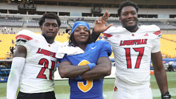 Sep 27, 2025; Pittsburgh, Pennsylvania, USA;  Pittsburgh Panthers wide receiver Cataurus Hicks (3) poses for a photo with Louisville Cardinals defensive back D'Angelo Hutchinson (21) and defensive lineman AJ Green (17) after the game at Acrisure Stadium. Mandatory Credit: Charles LeClaire-Imagn Images