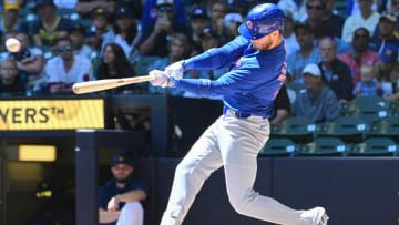 Jun 30, 2024; Milwaukee, Wisconsin, USA; Chicago Cubs designated hitter Cody Bellinger (24) hits a single against the Milwaukee Brewers in the first inning at American Family Field.