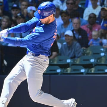 Jun 30, 2024; Milwaukee, Wisconsin, USA; Chicago Cubs designated hitter Cody Bellinger (24) hits a single against the Milwaukee Brewers in the first inning at American Family Field.