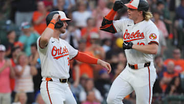 Jun 27, 2024; Baltimore, Maryland, USA; Baltimore Orioles outfielder Heston Kjerstad (13) greeted by designated hitter Ryan O’Hearn (32) following his two-run home run in the third inning against the Texas Rangers at Oriole Park at Camden Yards. Mandatory Credit: Mitch Stringer-Imagn Images